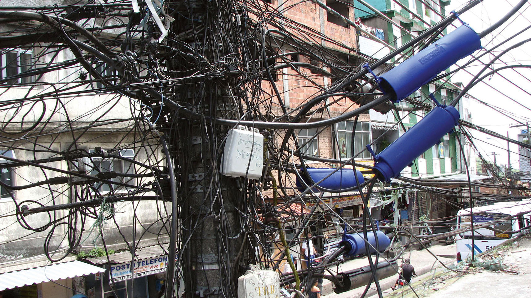 A tangle of wires on a power pole show that residents of this Brazilian neighborhood illegally tap power lines to access electricity without paying. (Photo by World Resources Council / Jonathan Talbot.)