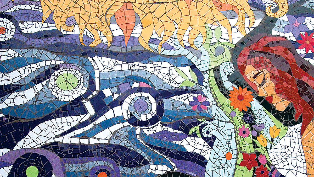 Detail of colorful tile mosaic of a pregnant woman with the sun, sea, and clouds, Santiago, Chile. (Photo by Carolina Macaya.)