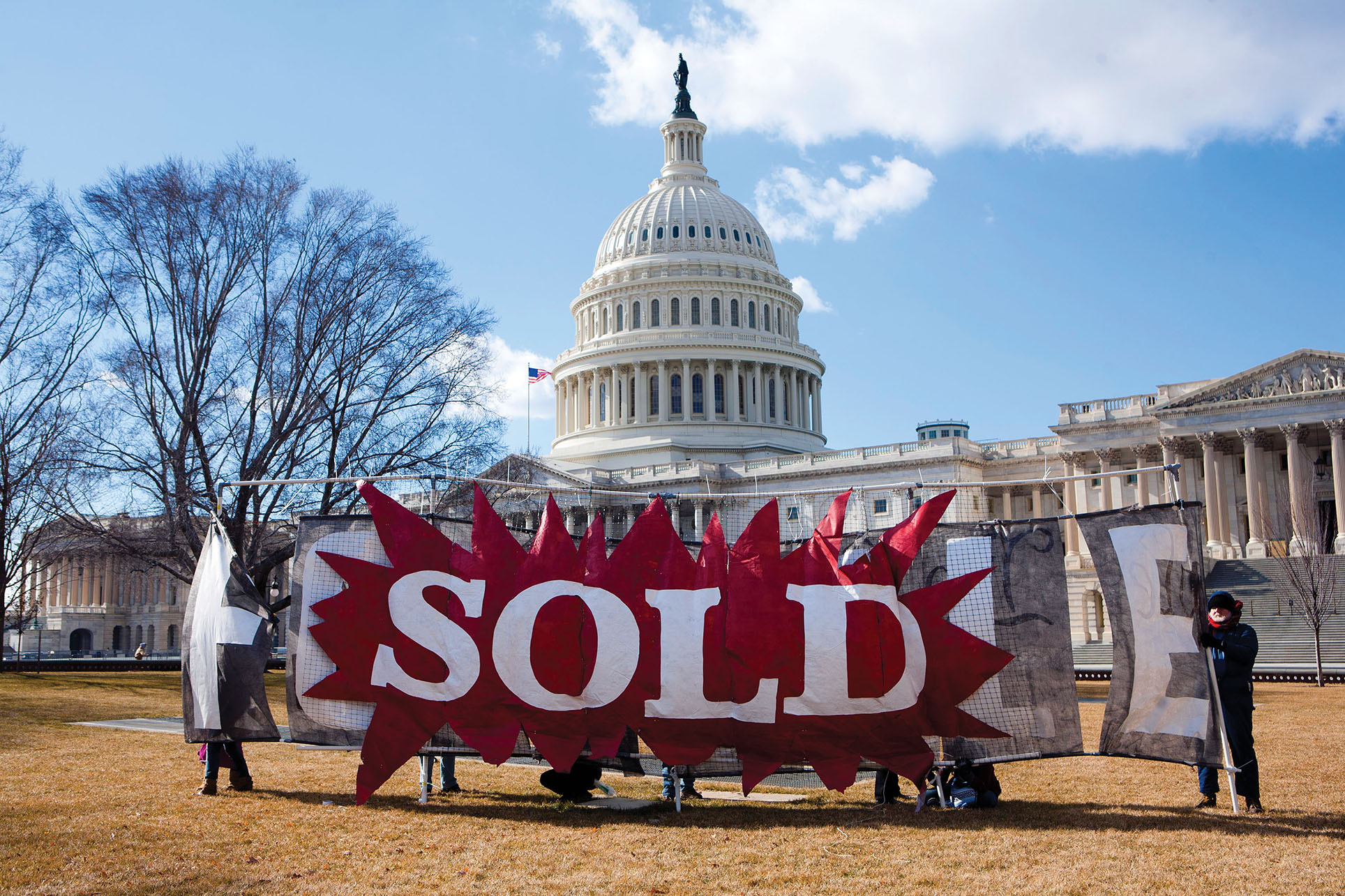 A "Sold" sign in front of the U.S. Capitol at a rally for a constitutional amendment to overturn the Citizens United Supreme Court decision. (Photo by Brendan Hoffman.)