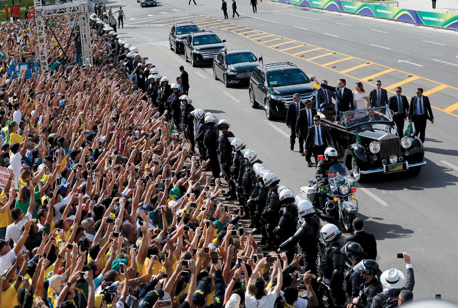 Brazilian President Jair Bolsonaro waves to supporters following his swearing-in ceremony, January 2019. (Photo by Silvia Izquierdo/AP Photo.)