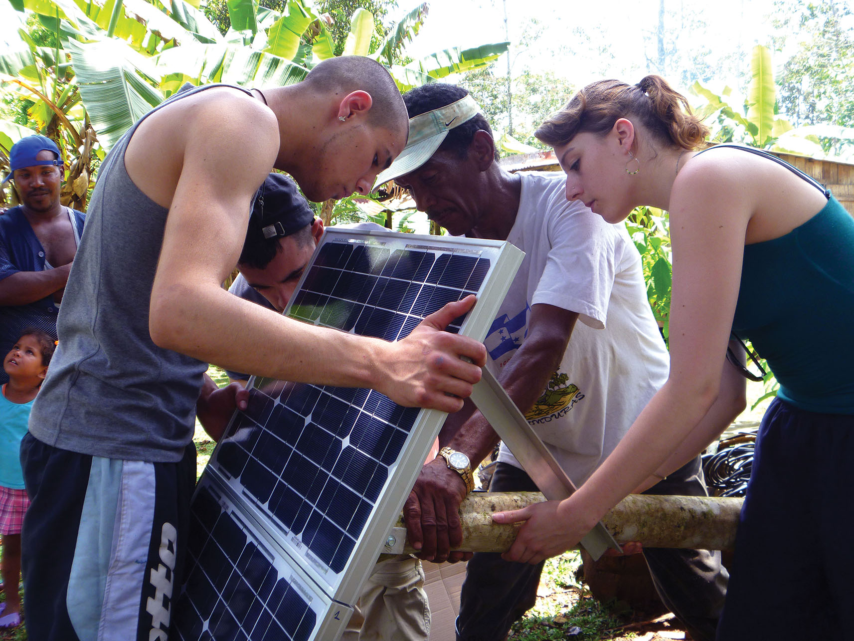 A group of people installing a solar panel in Rocky Point, Nicaragua, May 2012. (Photo courtesy of blueEnergy.)