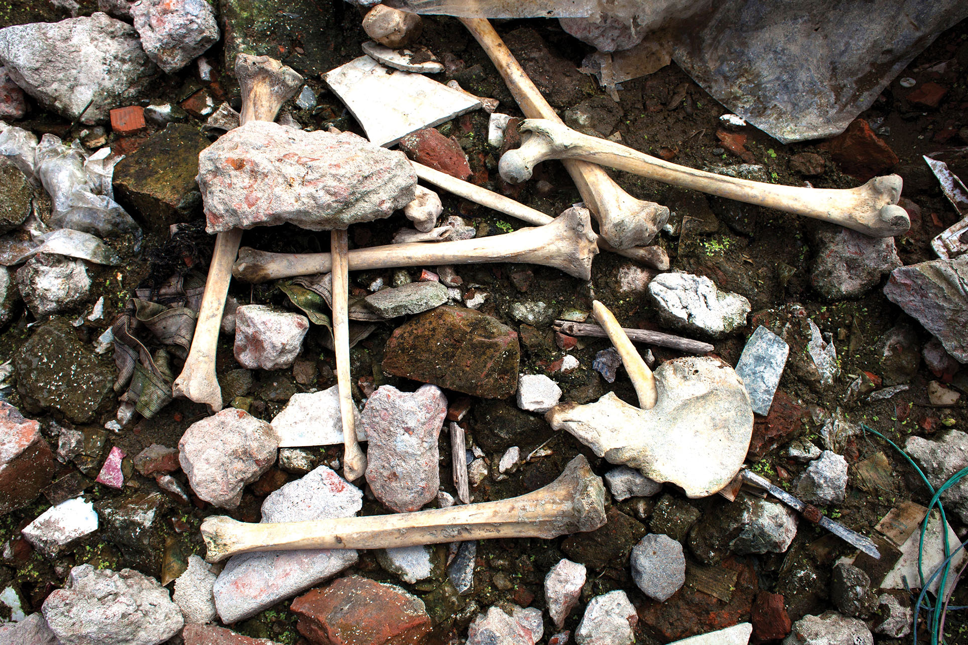 Human bones remain amidst the rubble two years after the Rana Plaza building collapse in Dhaka, Bangladesh. (Photo from Anadolu Agency/Getty Images.)