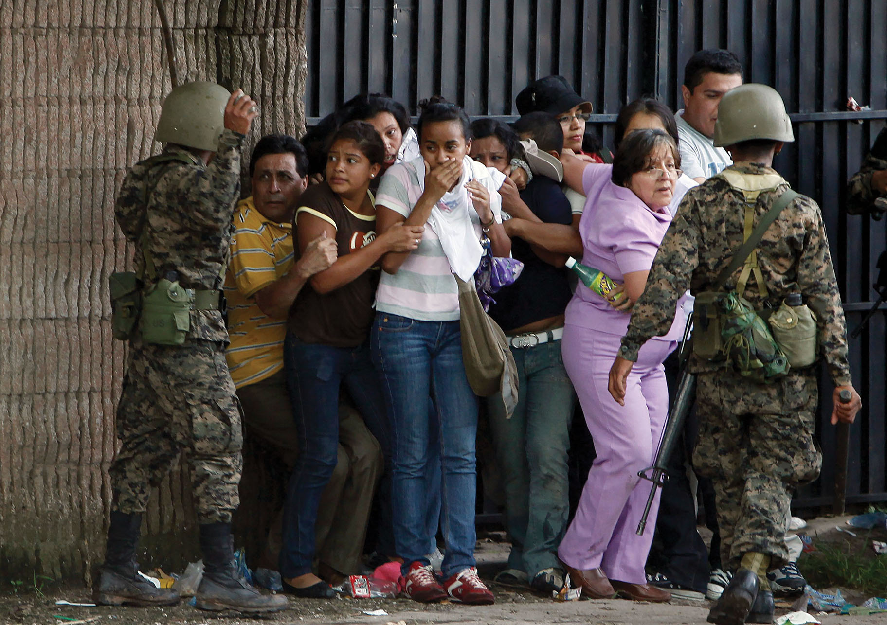 Honduran army soldiers surround supporters of ousted President Manuel Zelaya during the coup in Tegucigalpa, June 2009. (Photo by Eduardo Verdugo/AP Photo.)