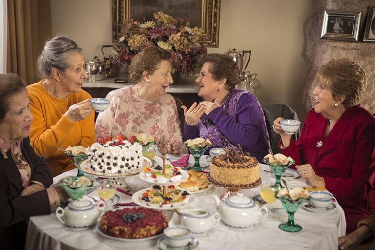 Five ladies having tea around a table. Still from “Tea Time"