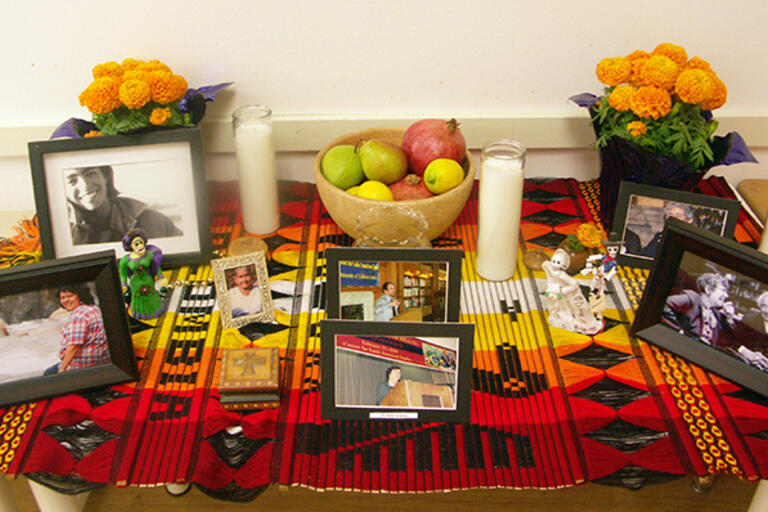 CLAS's altar for the Day of the Dead, colorful table with pictures and flowers