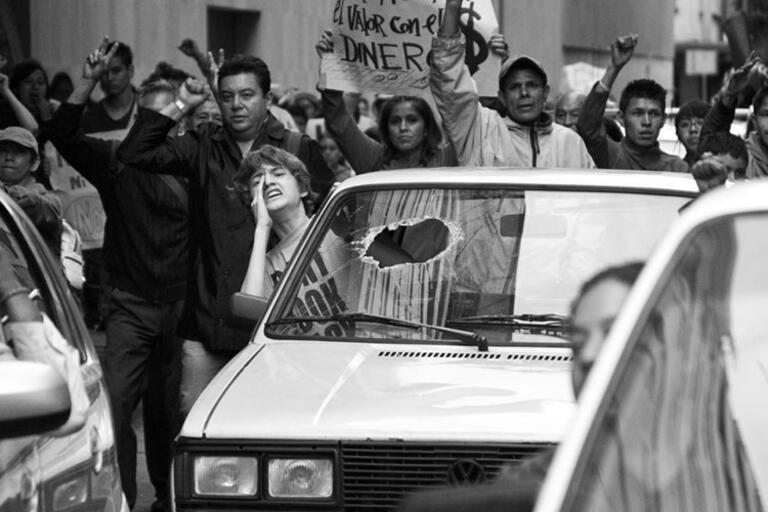 Black and white still from Güeros, people protesting 