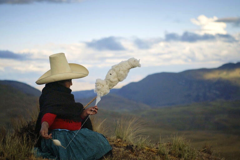 Máxima Acuña spins wool from her sheep. (Image courtesy of TrustFall Films.)