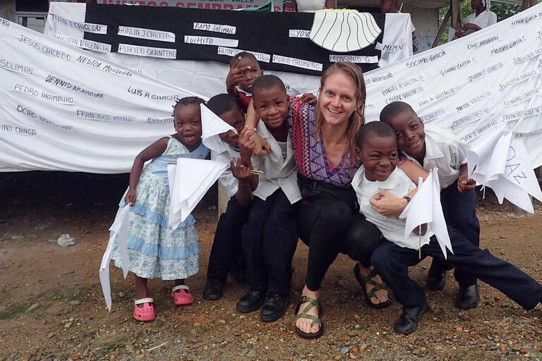 Author Lauren Withey with Colombian children after a peace march with a banner bearing the names of local victims of the conflict. (Photo courtesy of Lauren Withey.)