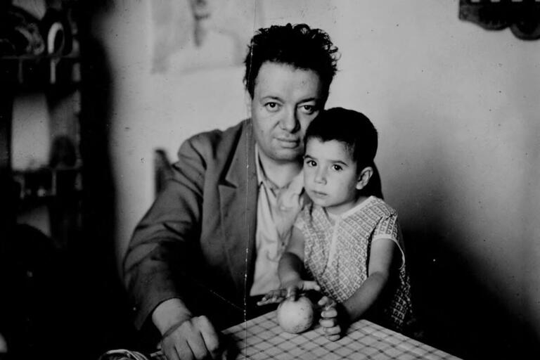 Diego Rivera sits with his toddler daughter Guadalupe on his lap, circa 1927. (Photo from Google Art Project/Wikimedia Commons.)