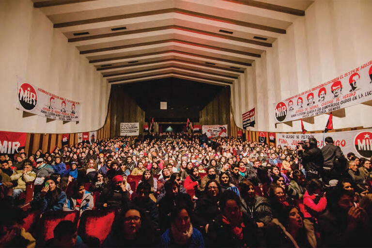 A large gathering of former members in a conference hall, commemorating the 50th anniversary of the Movimiento de Izquierda Revolucionaria, Concepción, Chile, August 2015. (Photo by Esteban Ignacio Paredes Drake.)