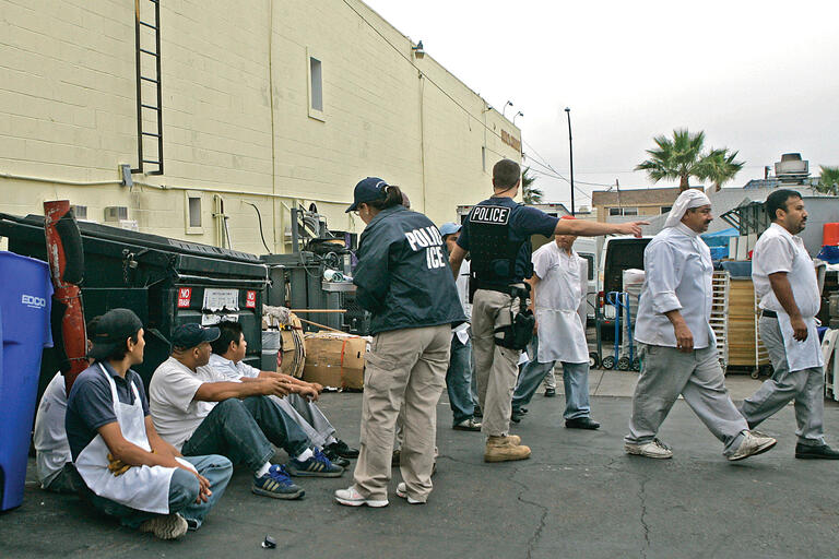 Immigration agents detain employees of San Diego’s French Gourmet Restaurant in a raid that led to felony indictments against the restaurant’s owner and manager. (Photo by Lenny Ignelzi/Associated Press.) Immigration agents detain employees of San Diego’s French Gourmet Restaurant in a raid that led to felony indictments against the restaurant’s owner and manager. (Photo by Lenny Ignelzi/Associated Press.)
