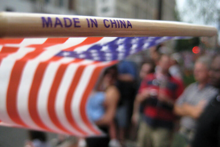 A small American flag with "Made in China" stamped on its staff at a July 4th parade in Harrisonburg, Virginia. (Photo by Brent Finnegan.)