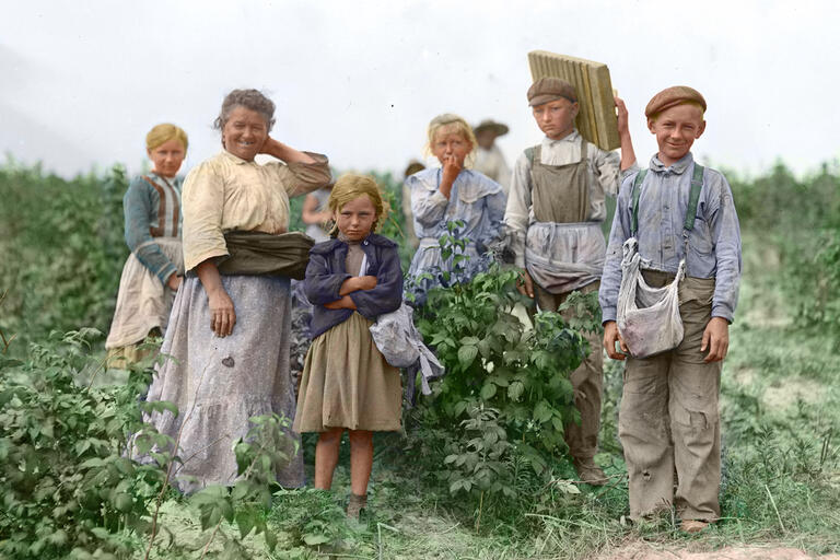 Earlier faces of immigration: a portrait of a family of Polish migrant berry pickers in Maryland in 1909. (Photo by Lewis Hine from Wikimedia Commons, colored by Robek.)