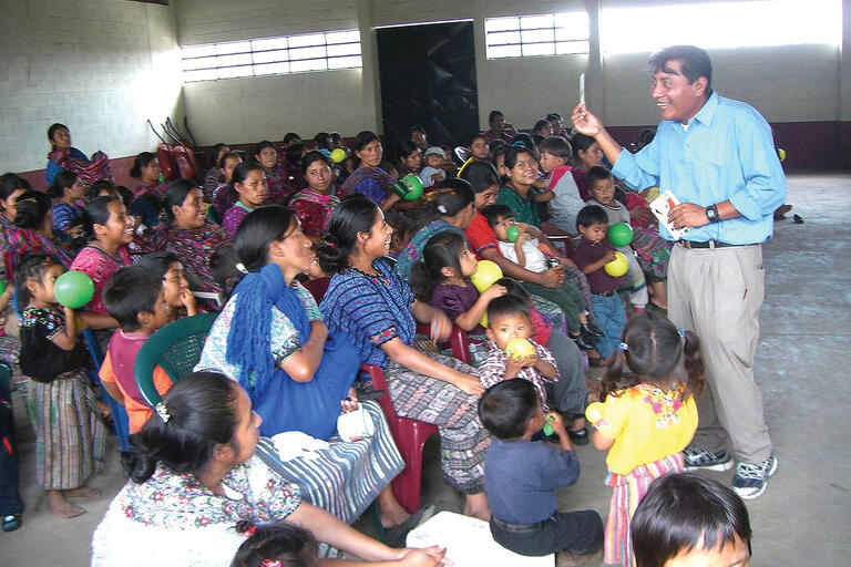 A local community health promoter educates a crowd in Guatemala. (Photo courtesy of Paul Wise.)