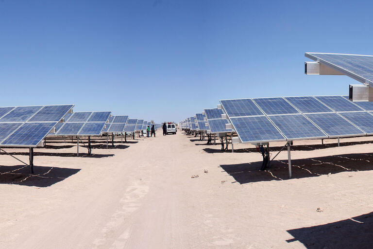 Looking down a dirt road through a massive photovoltaic array in the Atacama Desert, Chile. (Photo by Rodrigo Arancibia Zamora.)