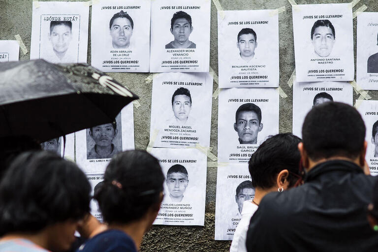 A display of photos and posters highlighting the missing Ayotzinapa students. (Photo by Jorge Mejia Peralta.)