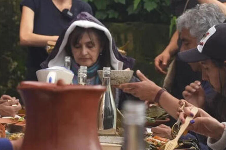 A photo of people eating around a table, linked to Lisa Blackmore's event on hydro-commoning.