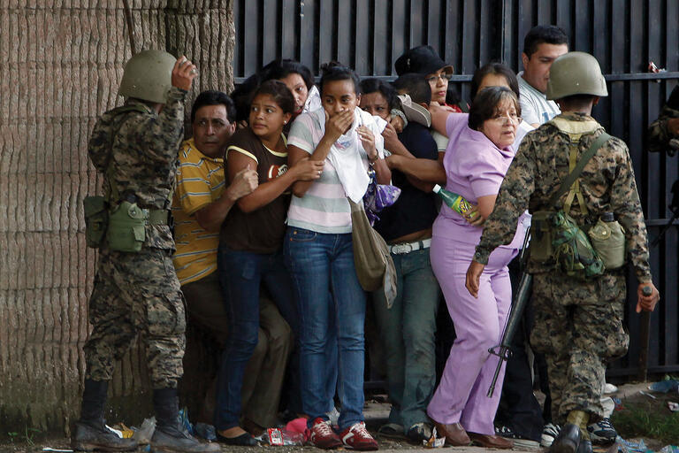 Honduran army soldiers surround supporters of ousted President Manuel Zelaya during the coup in Tegucigalpa, June 2009. (Photo by Eduardo Verdugo/AP Photo.)