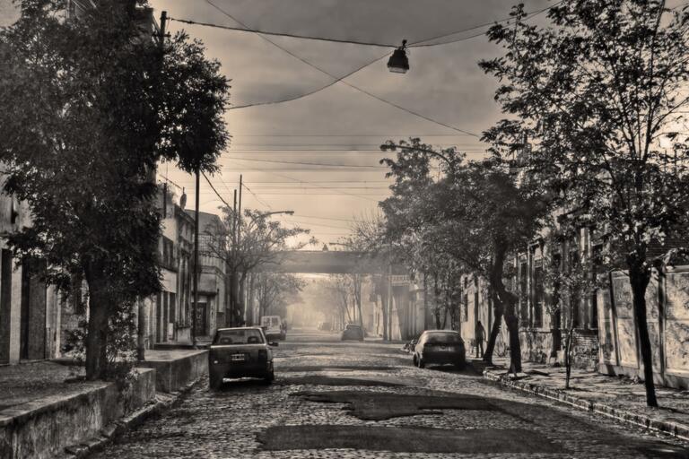 Street in Buenos Aires. (Photo by Ale Posta.) Black and white image of an empty street with two parked cars