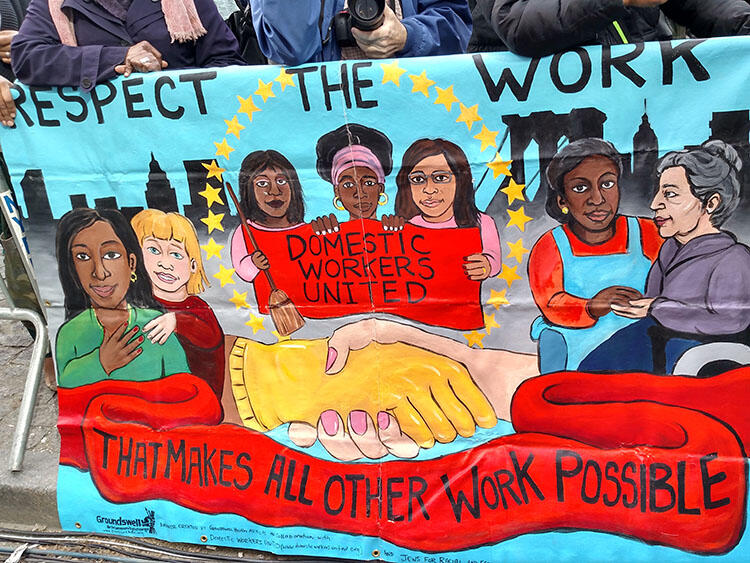 Mural painting that reads Respect the work, Domestic workers united, and that makes all other work possible