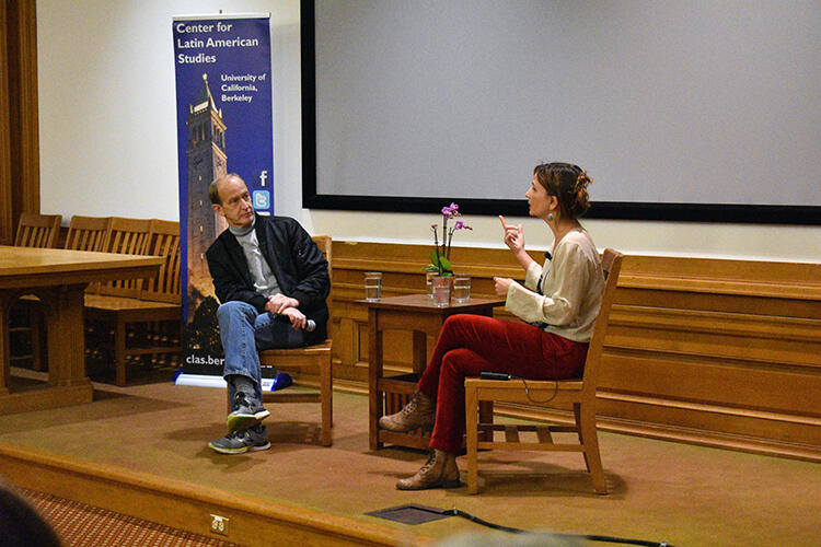 Petra Costa and Charles Ferguson seating in conversation with each other