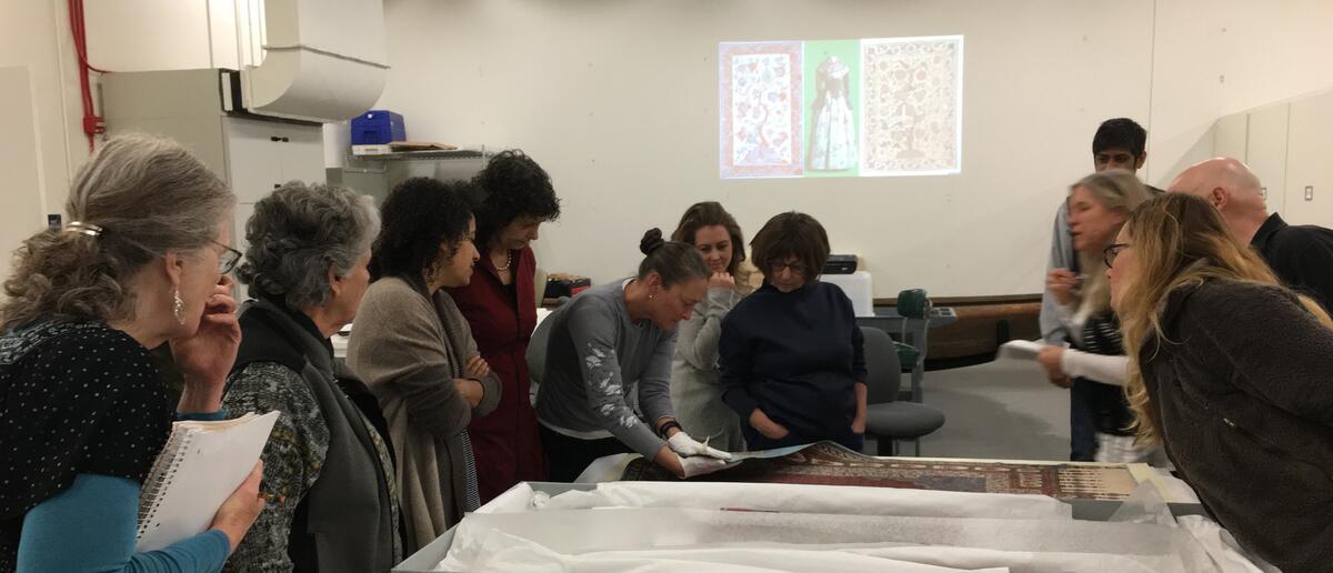 Group of teachers looking at fabric on a table