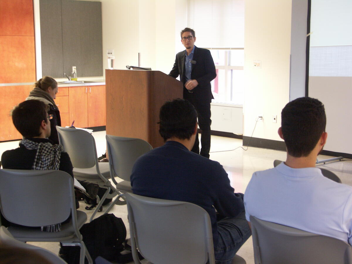 Beau Kilmer describing what is happening with marijuana legalization and discussing the design choices that will shape its consequences. The speaking is standing next to a podium and is speaking to crowd that we only begin to see on camera.
