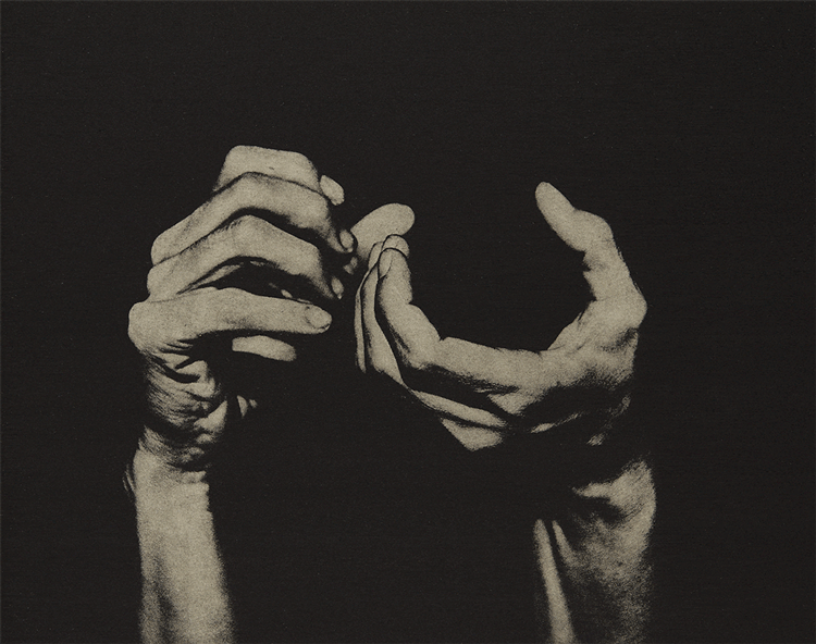 Black and white gif of hands pretending to take a photograph with no camera