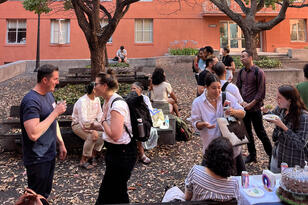 A group of people at a CLACS reception in Ishi Court at UC Berkeley.