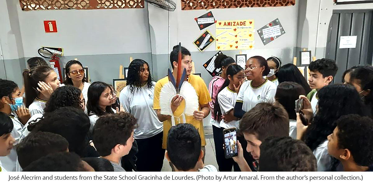 Indigenous artist José Alecrim standing among students from the State School Gracinha de Lourdes. (Photo by Artur Amaral. From the author’s personal collection.)