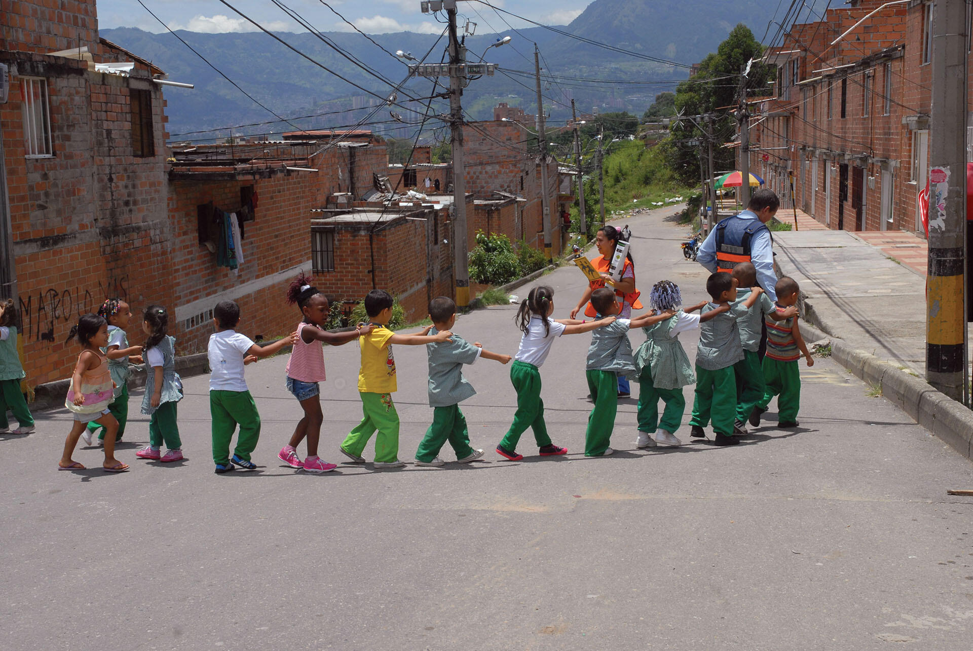 A group of colorfully clothed Medellín schoolchildren participate in an exercise program. (Photo courtesy of Secretaría de Movilidad de Medellín.)