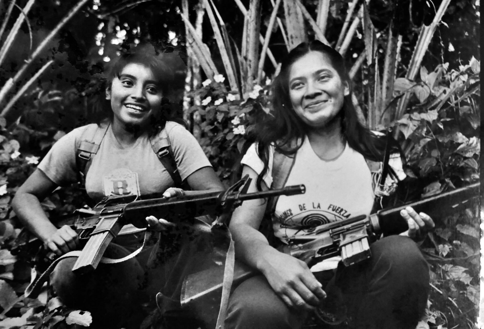 Two women Farabundo Martí National Liberation Front (FMLN) fighters holding guns smile at being photographed. (Photo courtesy of the Museo de la Revolucion, Perquin, El Salvador.)