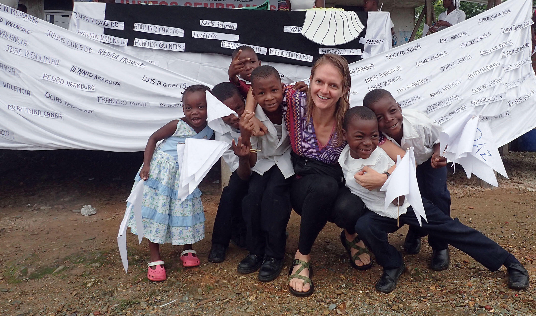 Author Lauren Withey with a group of Afro-Colombian children after a peace march with a banner bearing the names of local victims of the conflict. (Photo courtesy of Lauren Withey.)