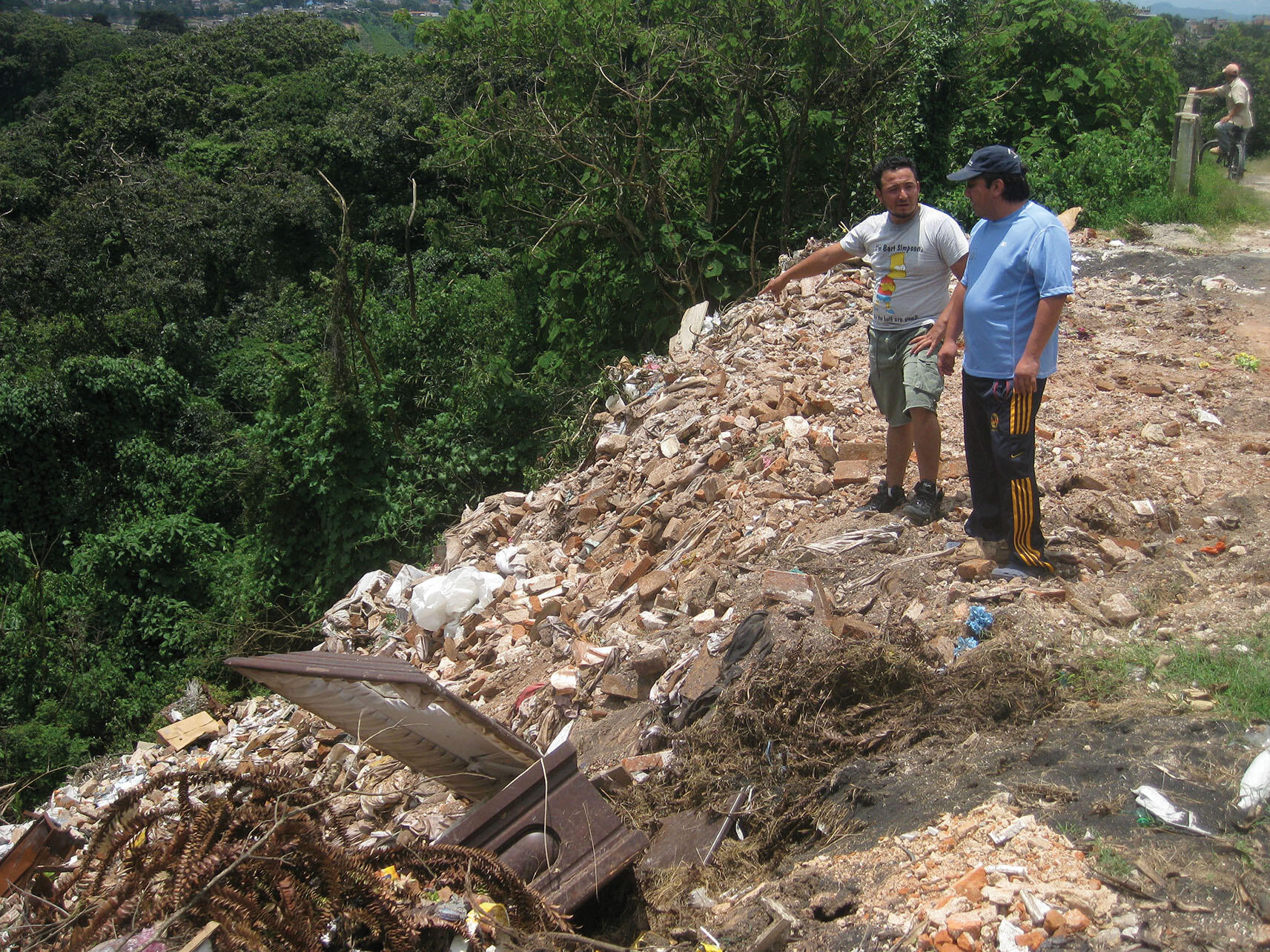 Juan and Guillermo stand at the border between the cemetery and the dump, where excess bodies are sometimes rolled down the hill from one to the other. (Photo by Anthony Fontes.)