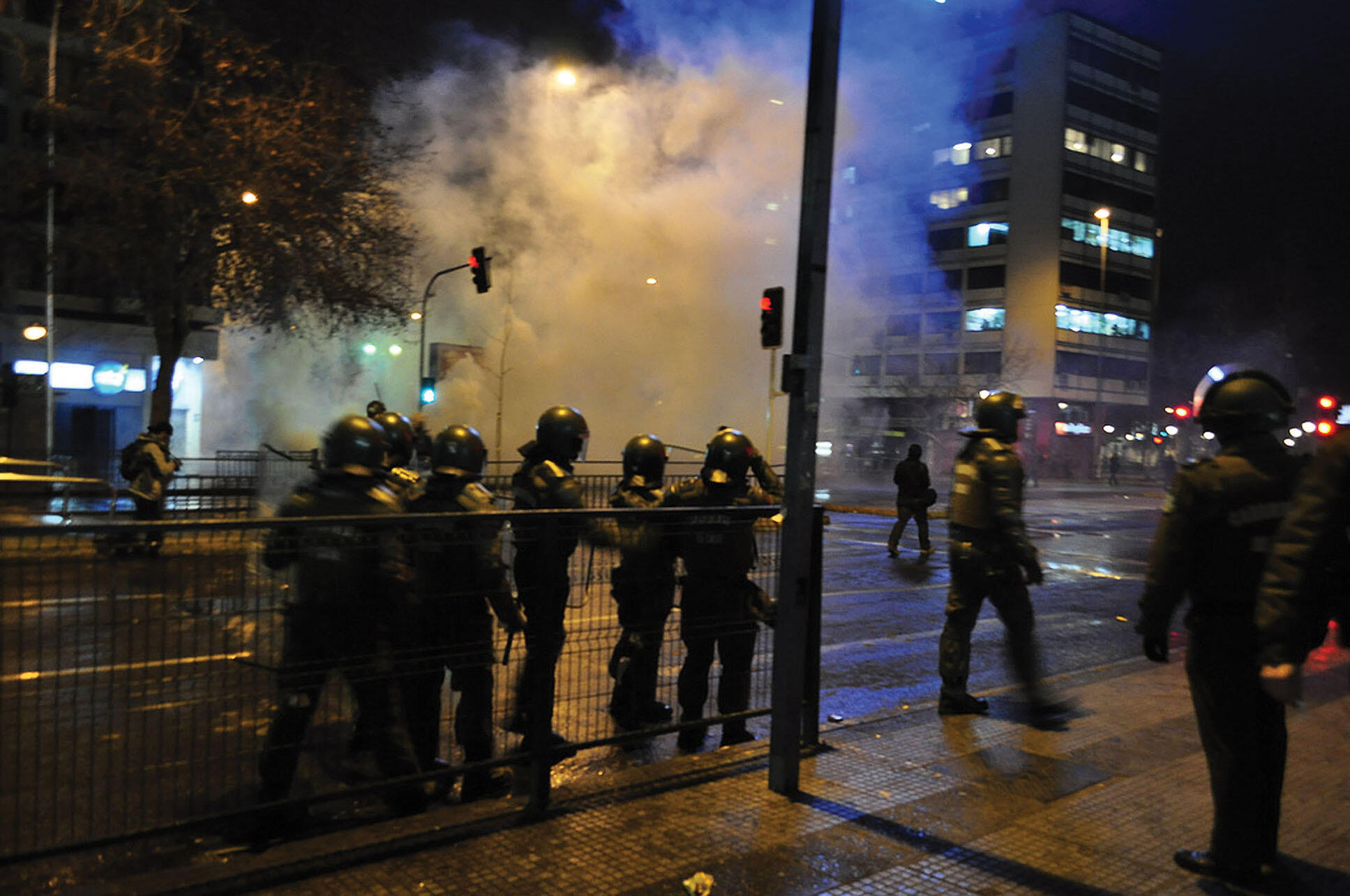 Chilean police in riot great respond to a student demonstration at night with tear gas,  August 2011. (Photo by Fabiola Torres.)