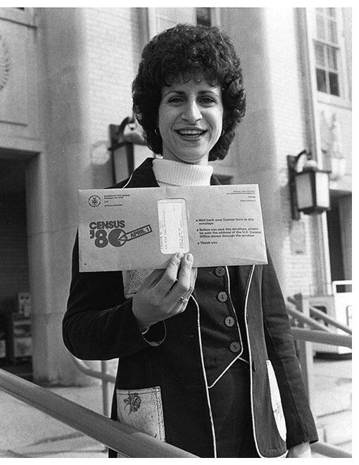 A woman holds up a 1980 census form, the first to include a “Hispanic” category. (Photo courtesy of the United States Census Bureau.)