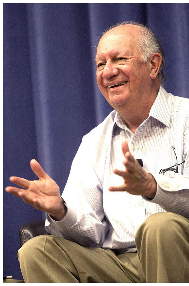 Ricardo Lagos laughs seated on stage while delivering a talk at UC Berkeley. (Photo by Jim Block.)