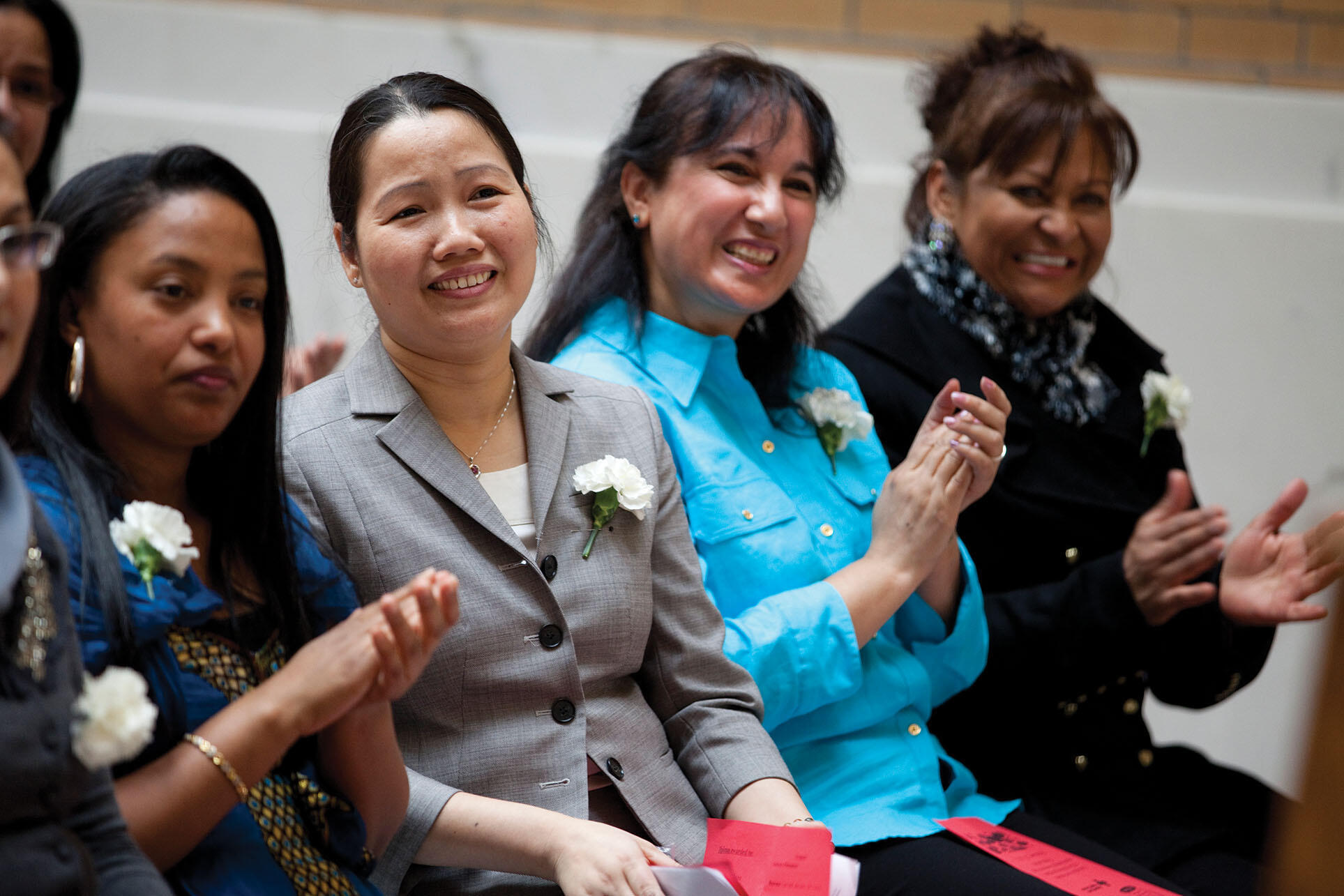 A group of immigrant women graduate from a program that teaches them both the English language and the skills they need to become certified nursing assistants.  (Photo by Melanie Stetson Freeman/The Christian Science Monitor/Getty Images.)