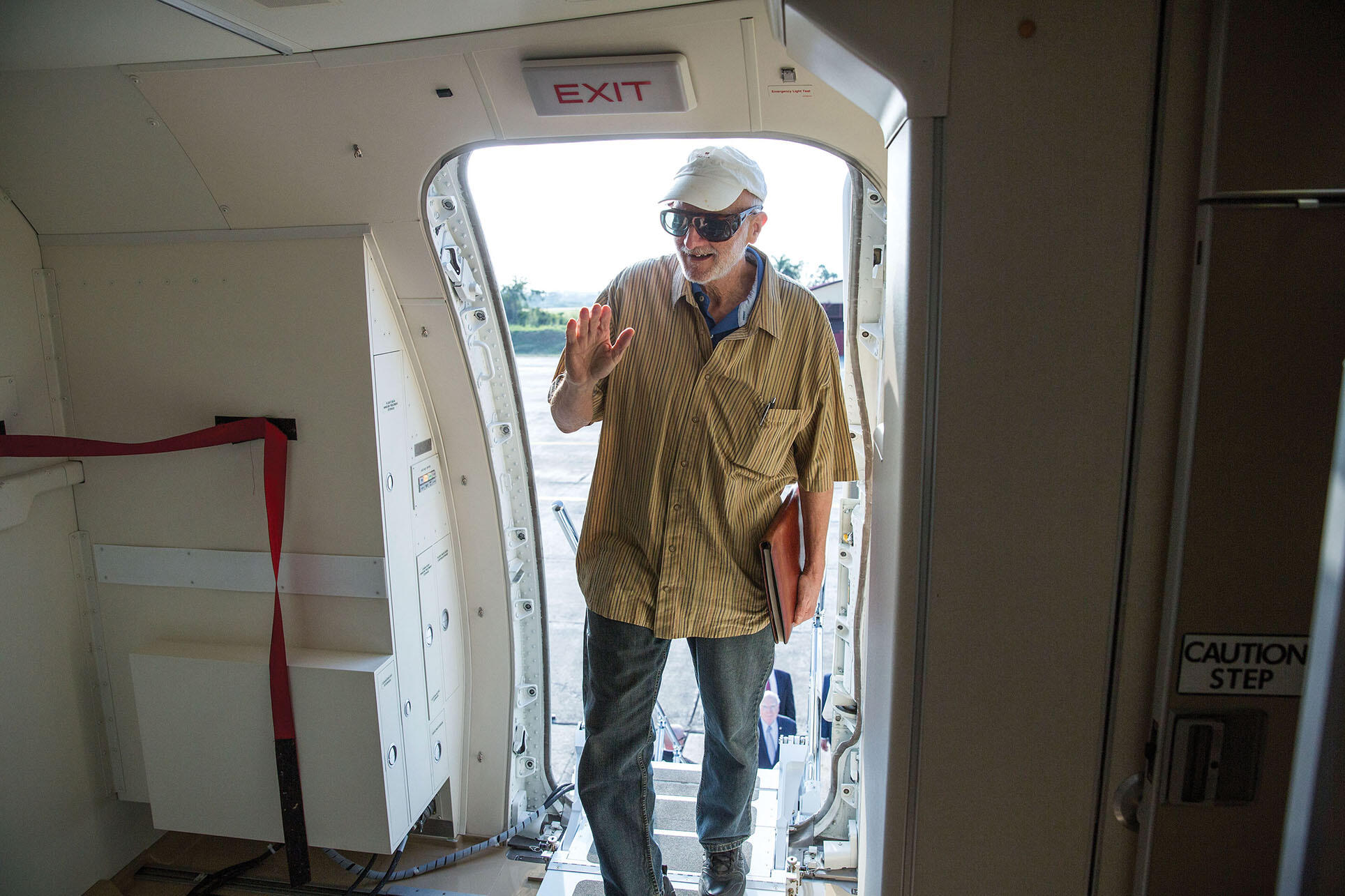 Alan Gross silhouetted in the door while boarding a U.S. government plane during his December 17, 2014, release at an airport near Havana, Cuba. (Photo by Lawrence Jackson/The White House via Getty Images.)