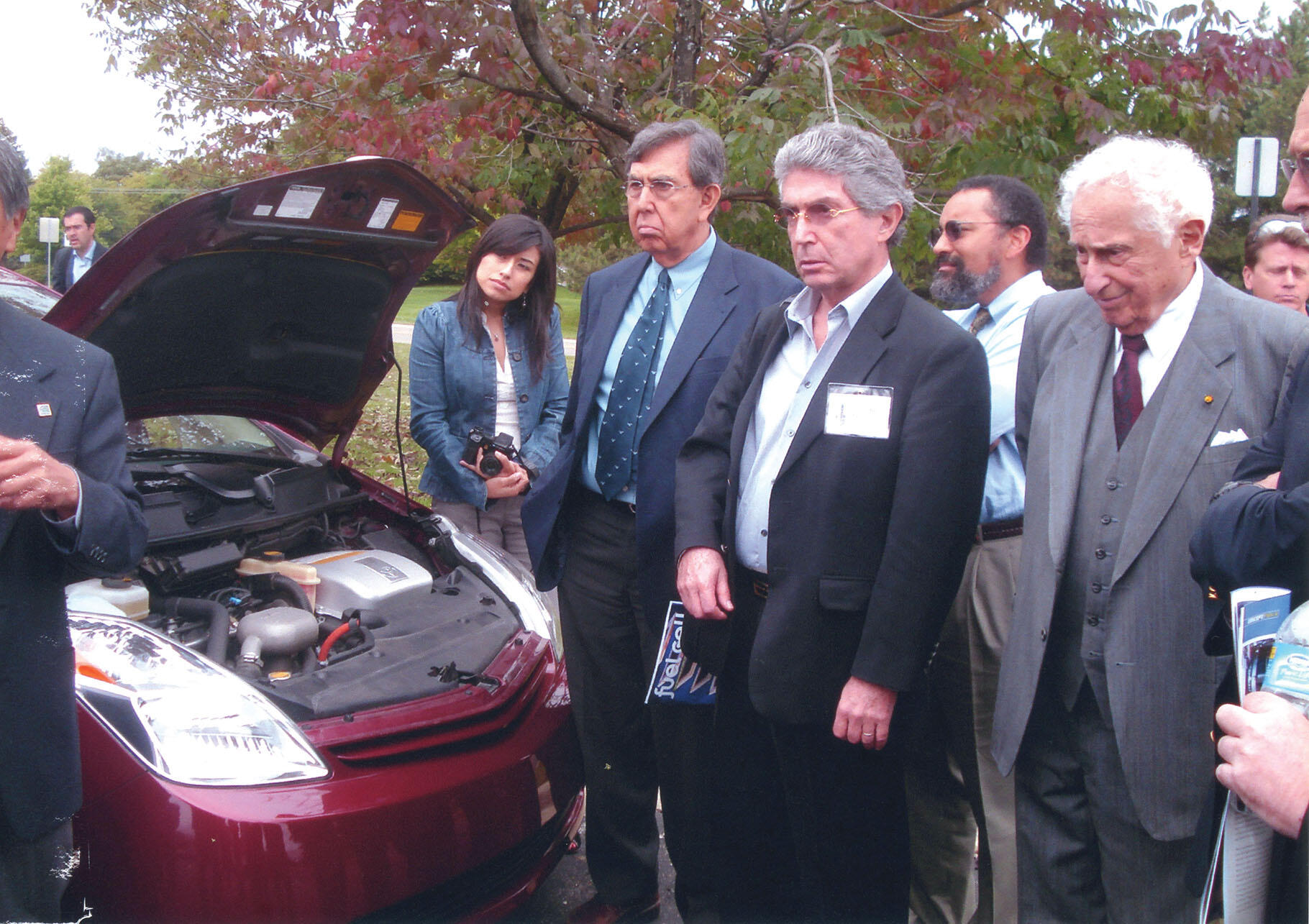  Forum participants meet scientist Stan Ovshinsky (right), with his award-winning prototype hydrogen car, Detroit, 2008. (Photo by Cristel Heinrich Bettoni.)