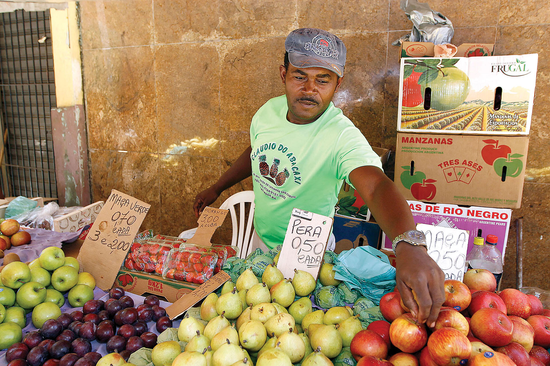  a fruit vendor sets up a stand on the street.