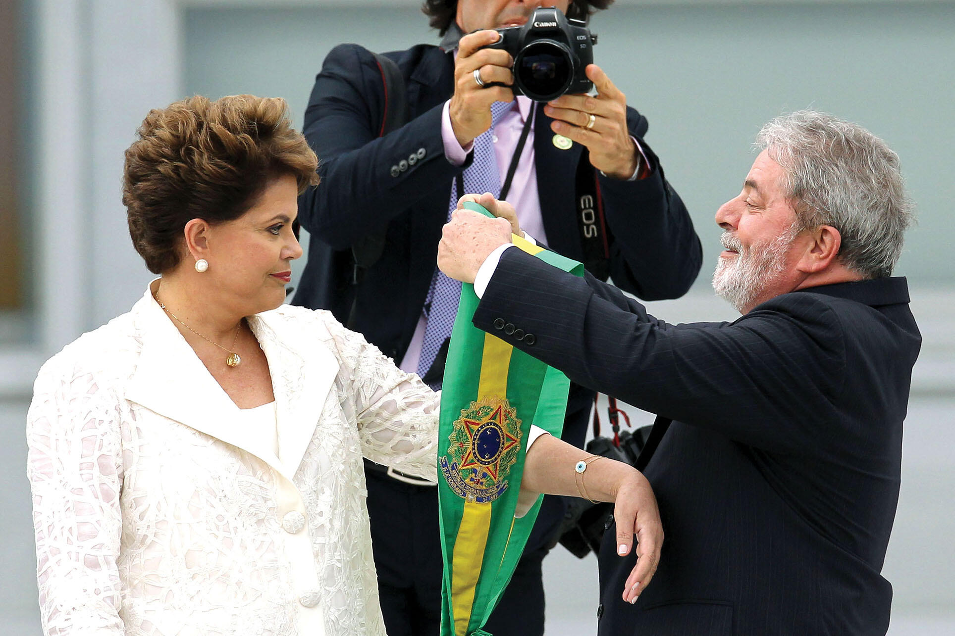 Lula hands over the presidential sash to Dilma Rousseff for her inauguration in 2011. (Photo by Celso Junior/Agência Estado/AE.) Lula hands over the presidential sash to Dilma Rousseff for her inauguration in 2011. (Photo by Celso Junior/Agência Estado/AE.)