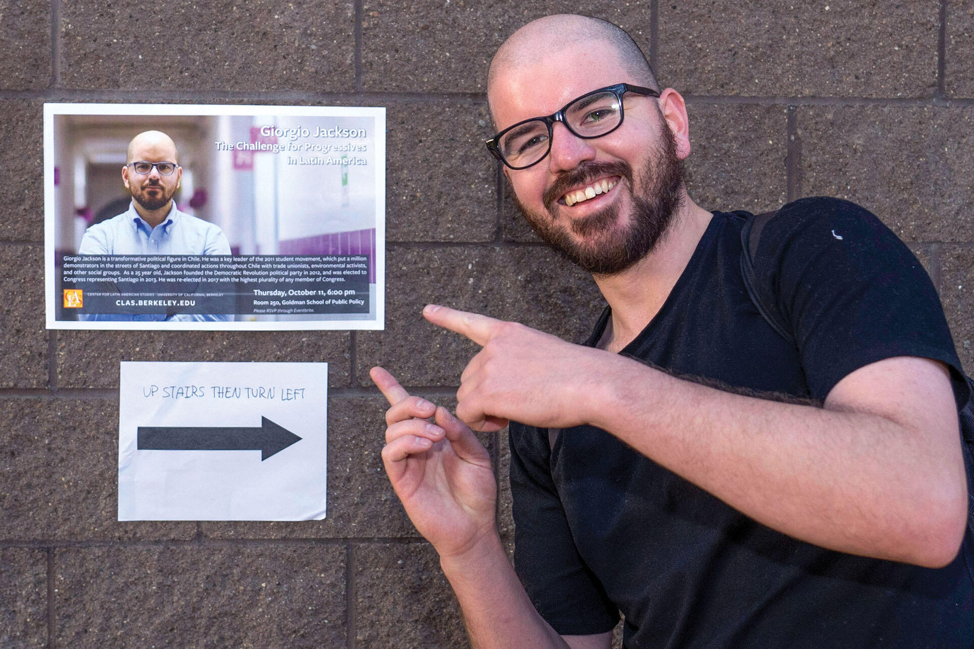 Giorgio Jackson with a poster advertising his talk at Berkeley, October 2018. (Photo by Jim Block.)