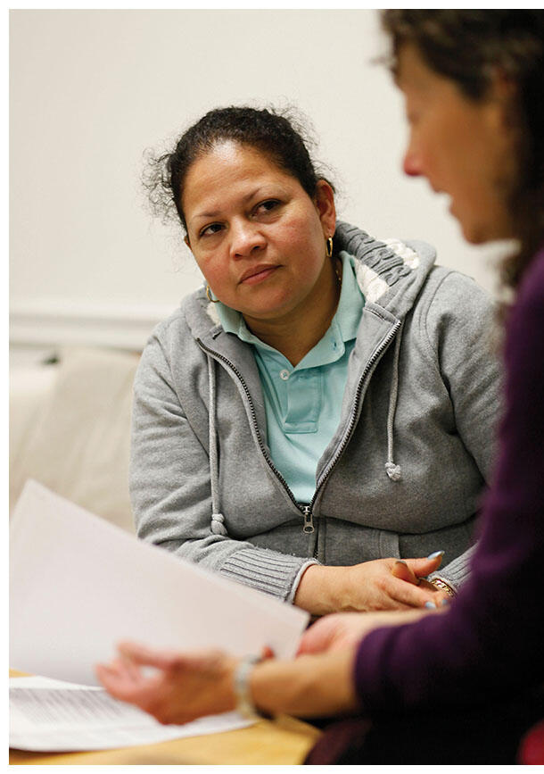 Rody Alvarado listens as her attorney Karen Musalo explains that her asylum petition was granted. (Photo by Eric Eisenberg/Associated Press.)