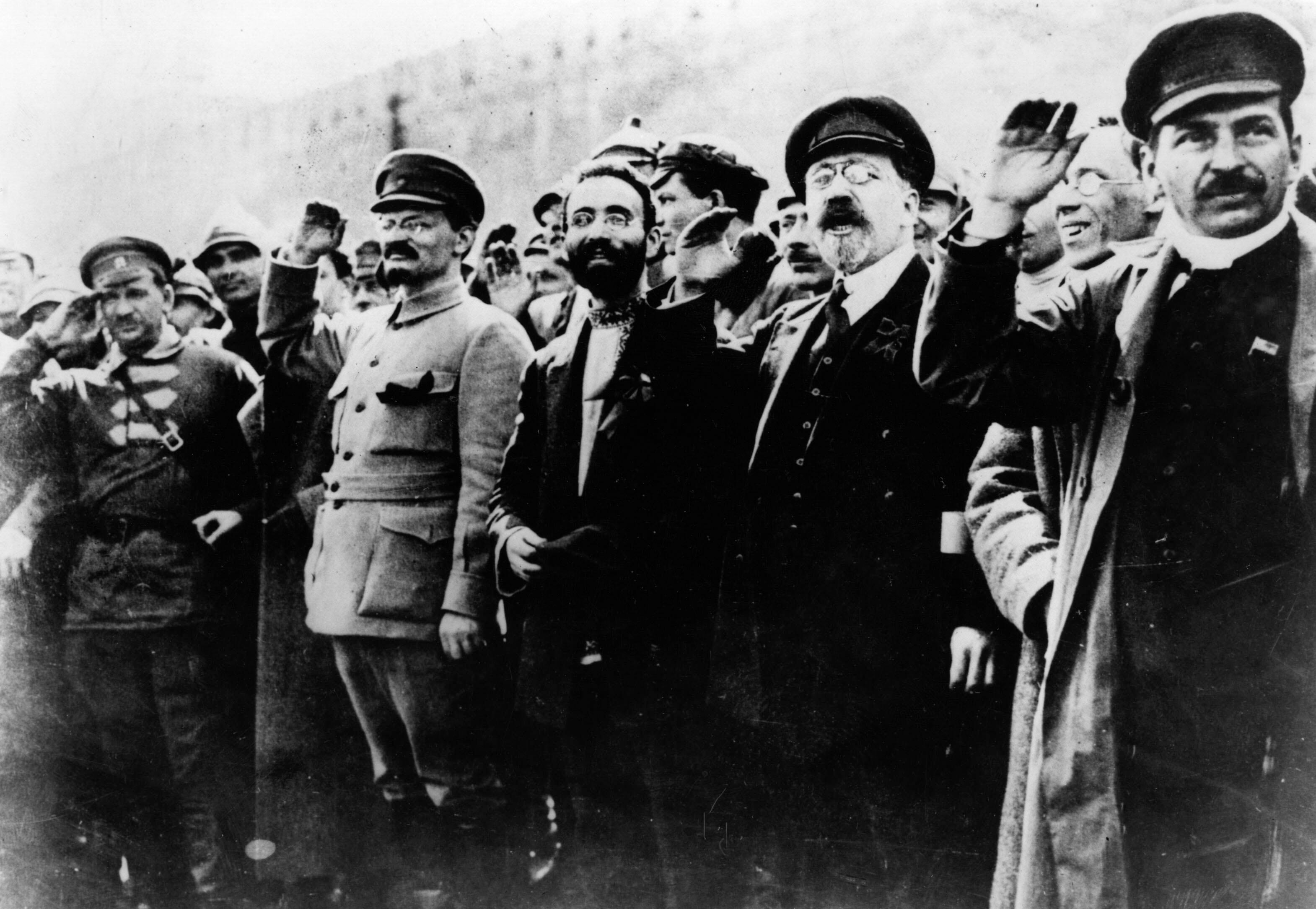 Communist leaders including Joseph Stalin (far right) and Leon Trotsky (second from left) salute supporters during the Russian Revolution. (Photo from Keystone/Getty Images.)