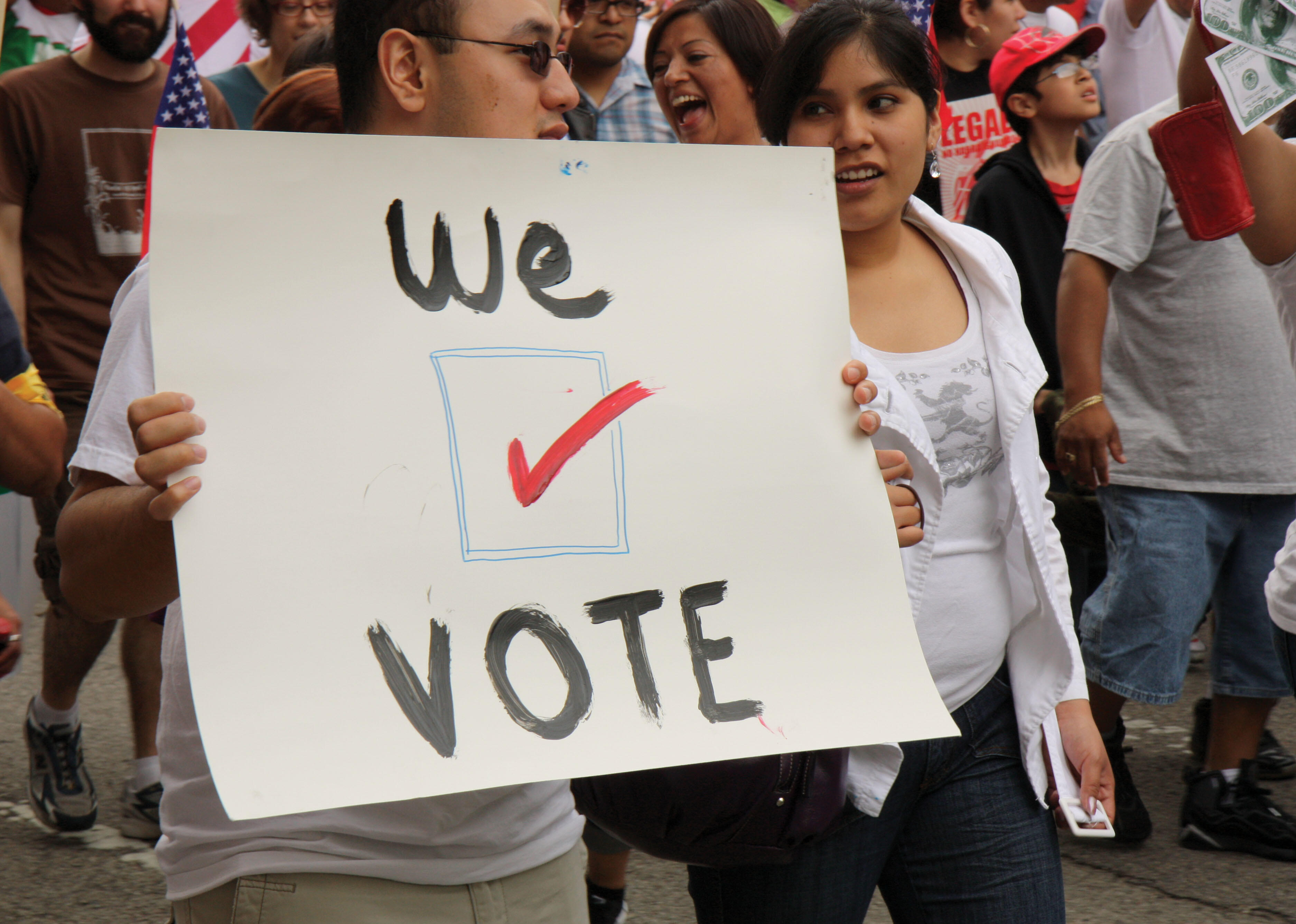 A demonstrator holds a sign reading "We vote" at a protest of Arizona’s Senate Bill 1070 in a May Day march in Chicago. (Photo by Carrie Sloan.)