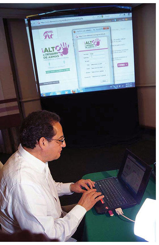 Sergio Aguayo sits at his laptop, tirelessly working on the campaign against gun trafficking, May 2011. (Photo courtesy of Alianza Cívica.)