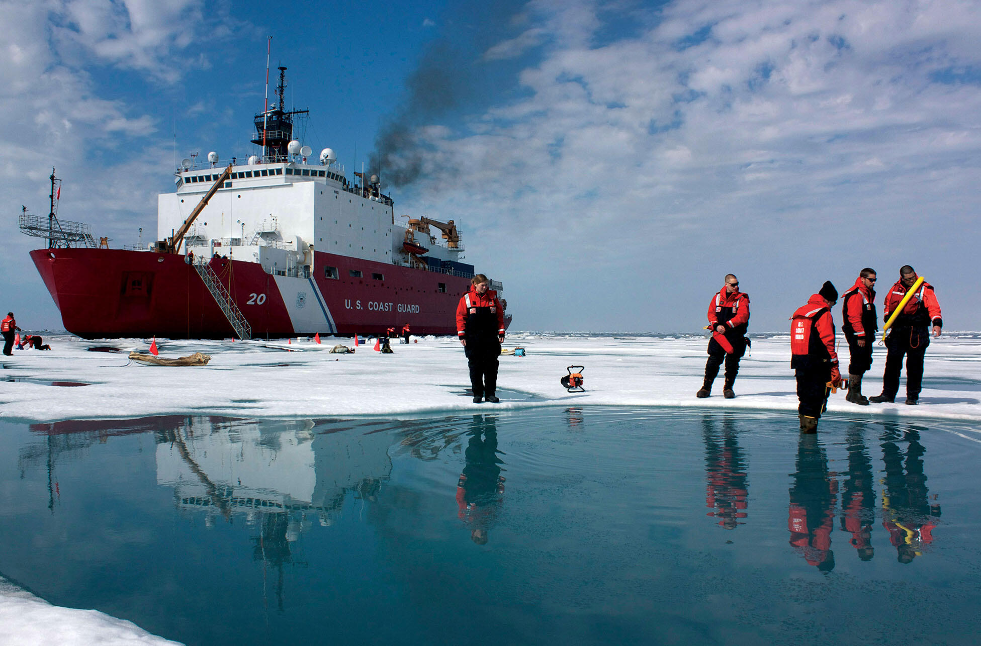 The crew of a U.S. Coast Guard ship measures the effects of climate change on the ice pack in the Arctic Sea. (Photo by Kathryn Hansen / NASA.)