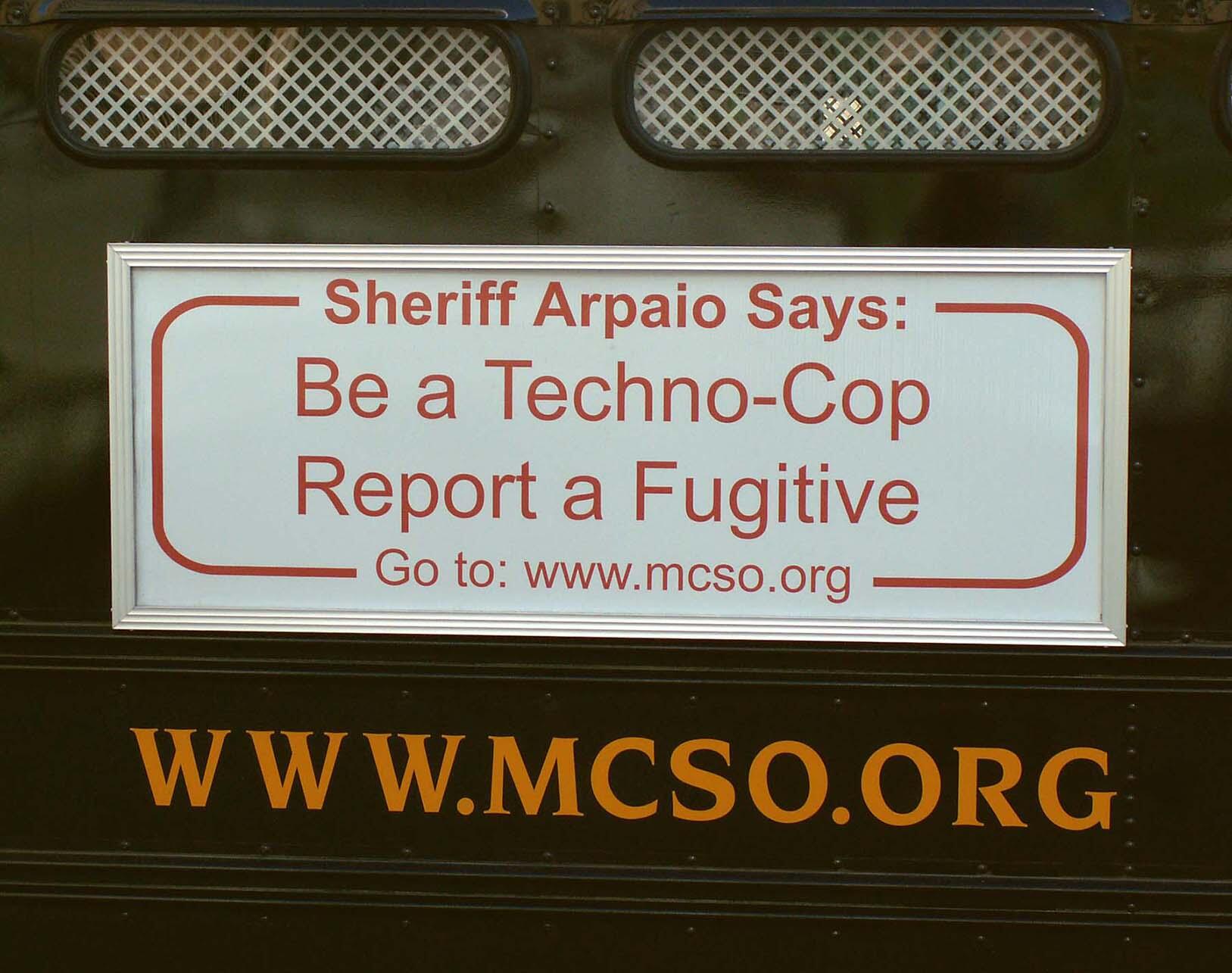  a bumper sticker encouraging reporting migrants to law enforcement. (Photo by cobalt123.)