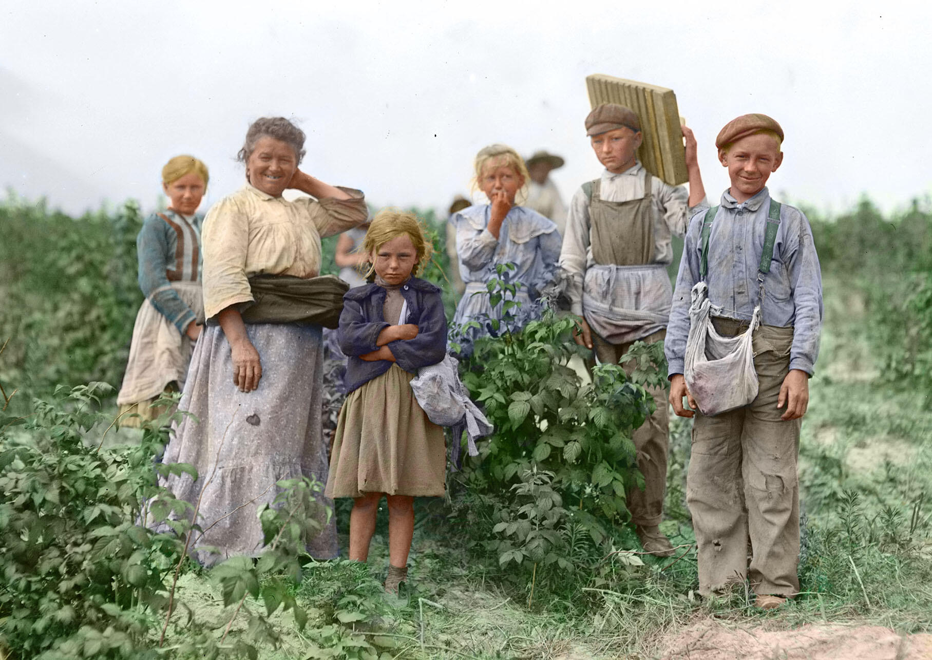 Earlier faces of immigration - a portrait of a family of Polish migrant berry pickers in Maryland in 1909. (Photo by Lewis Hine from Wikimedia Commons, colored by Robek.)